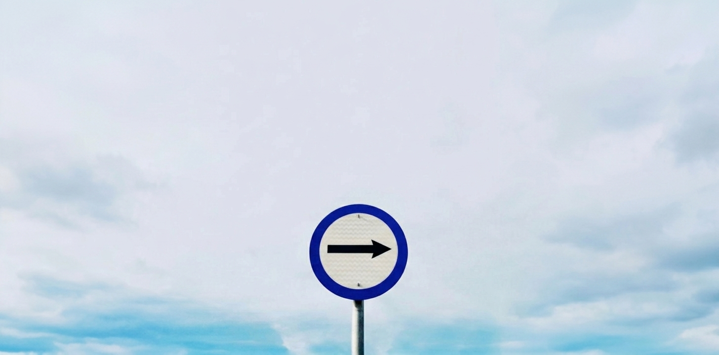 A clear directional arrow sign symbolizing a focused path forward